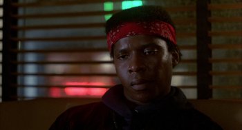 Movie still from “Quicksilver” (1986), directed by Thomas Michael Donnelly – A person wearing a head band; Close Up shot, Low angle