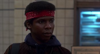 Movie still from “Quicksilver” (1986), directed by Thomas Michael Donnelly – A man with a red bandana on his head; Close Up shot, Low angle