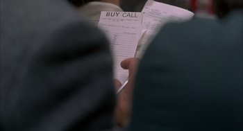 Movie still from “Quicksilver” (1986), directed by Thomas Michael Donnelly – A person holding a buy call receipt in their hand; Extreme Close Up shot, High angle