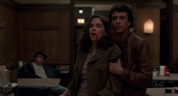 Movie still from “Quicksilver” (1986), directed by Thomas Michael Donnelly – A man and a woman with blood on their mouth; Medium shot, Over the shoulder angle