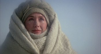 Movie still from “Quintet” (1979), directed by Robert Altman – A person wearing a hat and a scarf; Close Up shot, Low angle
