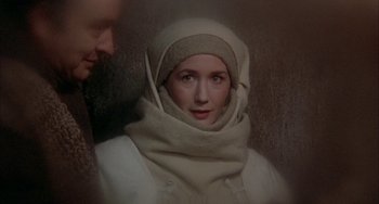 Movie still from “Quintet” (1979), directed by Robert Altman – A woman in a white coat and a man in a white suit; Close Up shot, Over the shoulder angle