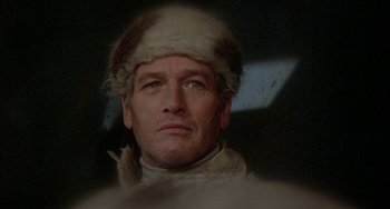 Movie still from “Quintet” (1979), directed by Robert Altman – A person wearing a hat; Close Up shot, Low angle