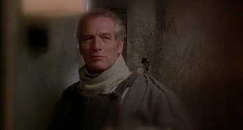 Movie still from “Quintet” (1979), directed by Robert Altman – A person wearing a neck scarf; Close Up shot, Low angle