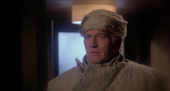 Movie still from “Quintet” (1979), directed by Robert Altman – A person wearing a hat; Close Up shot, Over the shoulder angle