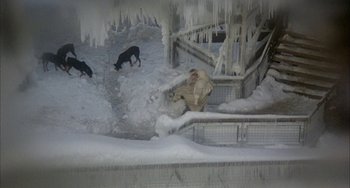 Movie still from “Quintet” (1979), directed by Robert Altman – A man and two dogs in the snow near a staircase; Wide shot, High angle