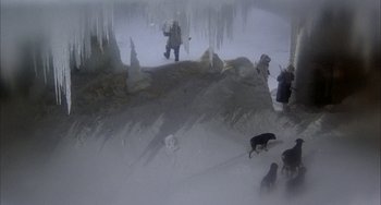 Movie still from “Quintet” (1979), directed by Robert Altman – A group of people and a dog in the snow; Wide shot, High angle