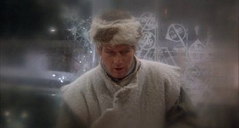 Movie still from “Quintet” (1979), directed by Robert Altman – A man wearing a fur hat and a white coat; Medium shot, Over the shoulder angle