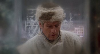 Movie still from “Quintet” (1979), directed by Robert Altman – A man wearing a fur hat and a white coat; Close Up shot, Over the shoulder angle