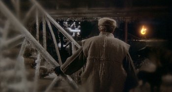 Movie still from “Quintet” (1979), directed by Robert Altman – An old man wearing a fur coat and a hat; Medium shot, Over the shoulder angle
