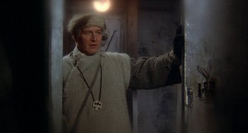 Movie still from “Quintet” (1979), directed by Robert Altman – A man wearing a fur coat and a hat; Medium shot, Low angle