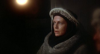 Movie still from “Quintet” (1979), directed by Robert Altman – A woman wearing a hooded sweater and a scarf; Close Up shot, High angle