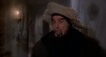 Movie still from “Quintet” (1979), directed by Robert Altman – A man with a beard and a cowboy hat on; Close Up shot, Over the shoulder angle