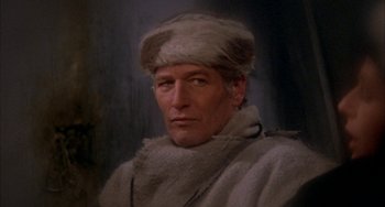 Movie still from “Quintet” (1979), directed by Robert Altman – A man wearing a fur hat and a fur coat; Close Up shot, High angle