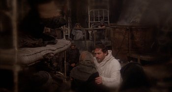 Movie still from “Quintet” (1979), directed by Robert Altman – A group of people standing in a room; Medium shot, High angle