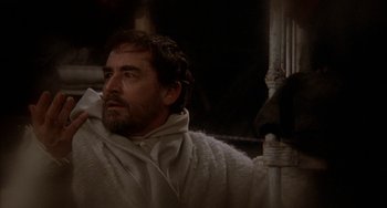 Movie still from “Quintet” (1979), directed by Robert Altman – A man with a beard is wearing a white robe; Medium shot, Low angle