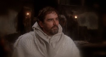 Movie still from “Quintet” (1979), directed by Robert Altman – A man with a beard wearing a white robe; Medium shot, Over the shoulder angle