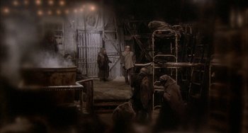 Movie still from “Quintet” (1979), directed by Robert Altman – A group of people standing around in a room; Wide shot, High angle