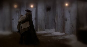 Movie still from “Quintet” (1979), directed by Robert Altman – A couple of people that are standing in the snow; Wide shot, High angle