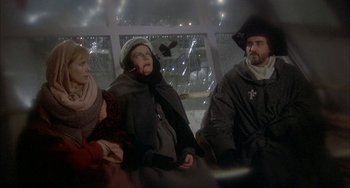 Movie still from “Quintet” (1979), directed by Robert Altman – A group of people sitting next to each other on a bus; Wide shot, High angle