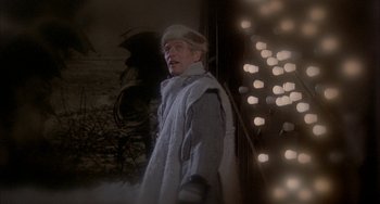 Movie still from “Quintet” (1979), directed by Robert Altman – A man wearing a white coat and a white hat; Medium shot, Low angle