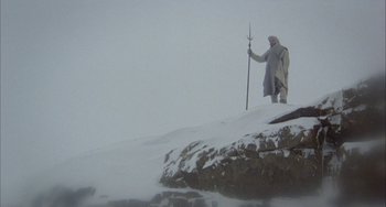 Movie still from “Quintet” (1979), directed by Robert Altman – A man standing on top of a snow covered hill; Wide shot, Low angle