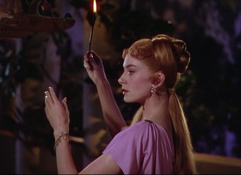Movie still from “Quo Vadis” (1951), directed by Anthony Mann – A woman holding a candle in her hand; Close Up shot, Over the shoulder angle