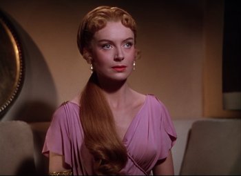 Movie still from “Quo Vadis” (1951), directed by Anthony Mann – A woman in a pink dress with long blonde hair; Close Up shot, Over the shoulder angle
