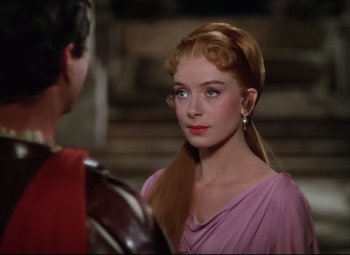 Movie still from “Quo Vadis” (1951), directed by Anthony Mann – A woman in a pink dress is talking to a man in a red suit; Close Up shot, Over the shoulder angle