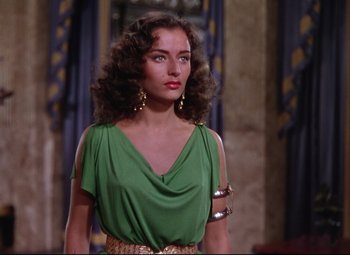 Movie still from “Quo Vadis” (1951), directed by Anthony Mann – A woman in a green top and a gold belt; Medium shot, Over the shoulder angle