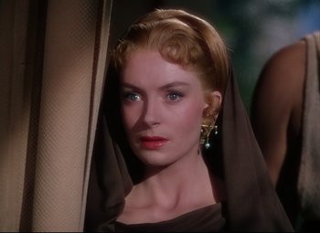 Movie still from “Quo Vadis” (1951), directed by Anthony Mann – A beautiful woman with red lipstick wearing a veil; Close Up shot, Over the shoulder angle