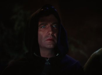 Movie still from “Quo Vadis” (1951), directed by Anthony Mann – A man in a hooded jacket stares into the distance; Close Up shot, Over the shoulder angle