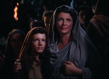 Movie still from “Quo Vadis” (1951), directed by Anthony Mann – A woman and a boy are standing in a crowd of people; Medium shot, Low angle
