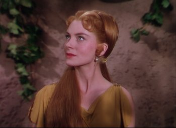 Movie still from “Quo Vadis” (1951), directed by Anthony Mann – A beautiful woman with long red hair wearing a yellow dress; Close Up shot, Over the shoulder angle