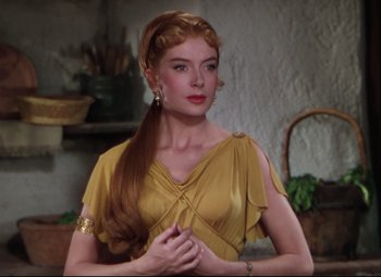 Movie still from “Quo Vadis” (1951), directed by Anthony Mann – A woman with long red hair wearing a yellow dress; Close Up shot, Over the shoulder angle