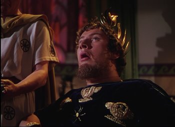 Movie still from “Quo Vadis” (1951), directed by Anthony Mann – A man with a beard and a gold crown on; Medium shot, Low angle