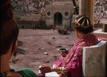 Movie still from “Quo Vadis” (1951), directed by Anthony Mann – A man sitting on top of a chair wearing a crown; Extreme Wide shot, High angle