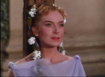 Movie still from “Quo Vadis” (1951), directed by Anthony Mann – A woman with flowers in her blonde hair and blue eyes; Close Up shot, Over the shoulder angle