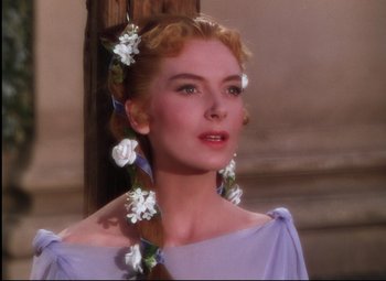 Movie still from “Quo Vadis” (1951), directed by Anthony Mann – A beautiful woman with long blonde hair wearing a purple dress; Close Up shot, Over the shoulder angle