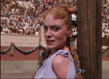 Movie still from “Quo Vadis” (1951), directed by Anthony Mann – A woman with red hair wearing a purple dress; Close Up shot, Low angle