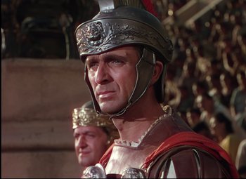 Movie still from “Quo Vadis” (1951), directed by Anthony Mann – A man in a roman soldier's outfit and helmet; Close Up shot, Low angle