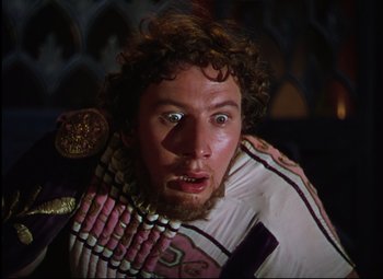 Movie still from “Quo Vadis” (1951), directed by Anthony Mann – A person with a beard wearing a costume; Close Up shot, Low angle