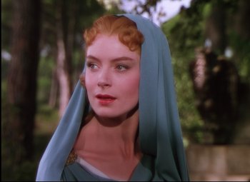 Movie still from “Quo Vadis” (1951), directed by Anthony Mann – A woman with red hair wearing a blue head covering; Close Up shot, Over the shoulder angle