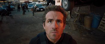 Movie still from “R.I.P.D.” (2013), directed by Robert Schwentke – A person looking at the camera; Close Up shot, Low angle