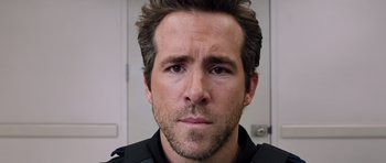 Movie still from “R.I.P.D.” (2013), directed by Robert Schwentke – A person wearing a black shirt; Close Up shot, Over the shoulder angle