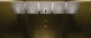Movie still from “R.I.P.D.” (2013), directed by Robert Schwentke – A man standing in a room with a camera; Extreme Wide shot, Overhead angle