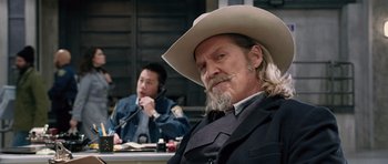 Movie still from “R.I.P.D.” (2013), directed by Robert Schwentke – A man with a cowboy hat sitting next to another man; Medium shot, Over the shoulder angle