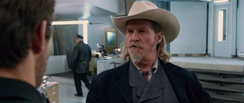 Movie still from “R.I.P.D.” (2013), directed by Robert Schwentke – A man with a long beard wearing a cowboy hat; Close Up shot, Over the shoulder angle