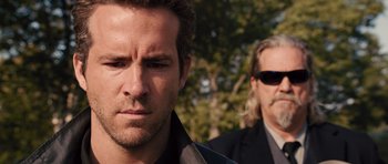 Movie still from “R.I.P.D.” (2013), directed by Robert Schwentke – A man and a man in a suit and sunglasses; Close Up shot, Over the shoulder angle