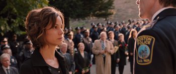 Movie still from “R.I.P.D.” (2013), directed by Robert Schwentke – A woman standing in front of a group of people; Close Up shot, Over the shoulder angle
